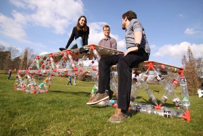 Science Experiments for High School Bottle Bridge Students sitting on a large bridge made of plastic bottles