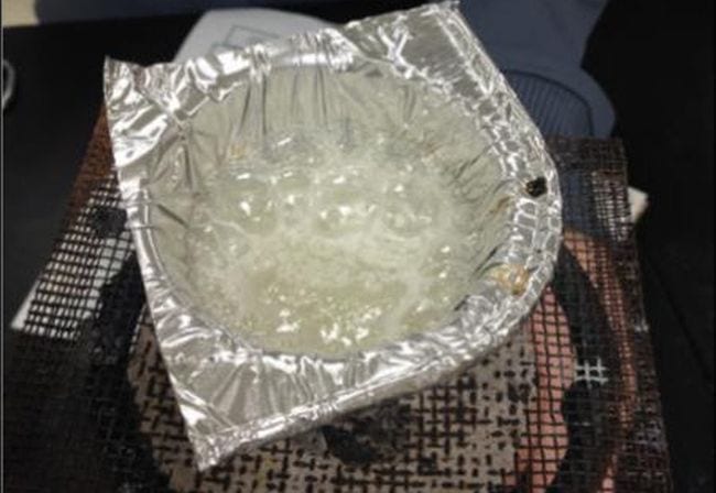 Science Experiments for High School Candy Chemistry Aluminum foil bowl filled with bubbling liquid over a bunsen burner
