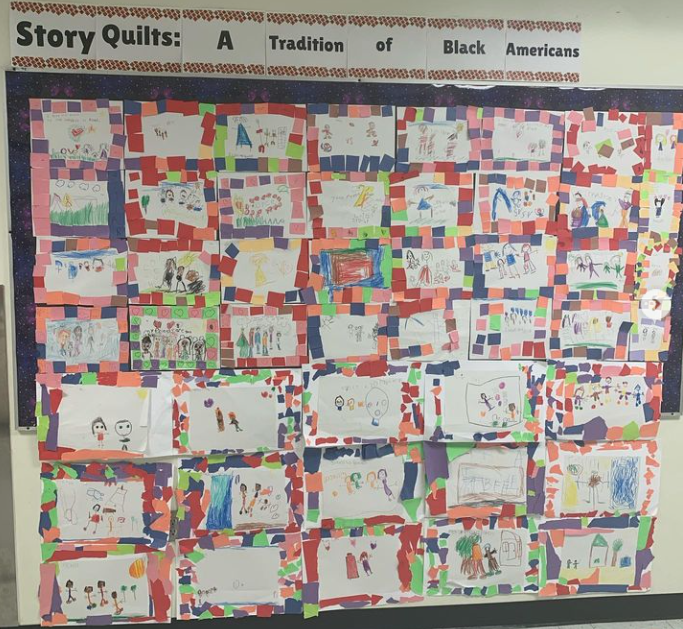 Black History Month Bulletin Board – Story Quilt A bulletin board is covered in paper quilts made by students.