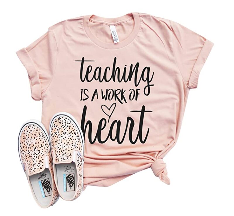 Valentine’s Day Teacher T-Shirt Pink Valentine's Day t-shirt that says Teaching Is a Work of Heart along with a pair of leopard print sneakers.