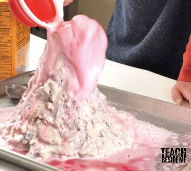 Volcano Science Experiments Classic Project Student pouring vinegar into a salt dough volcano