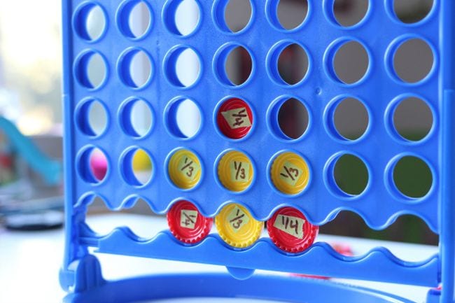 connect-4-fraction-game A Connect 4 game is set up with red and yellow discs signifying fractions as an example of fraction games and activities
