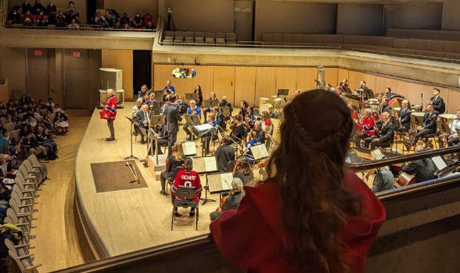 Field Trip Ideas: Elementary Child looking down on stage set up for orchestra concert