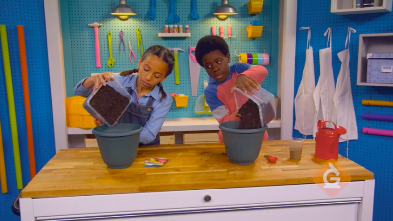 Compare Soil Two schoolchildren pouring dirt into pots