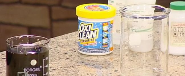 8th Grade Science Cleaning Steve Spangler Container of OxiClean with beakers of liquid on a counter