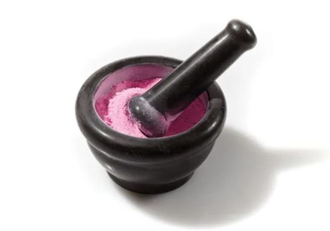 8th Grade Science Pepto Popular Science Black mortar filled with pink powder and a pestle