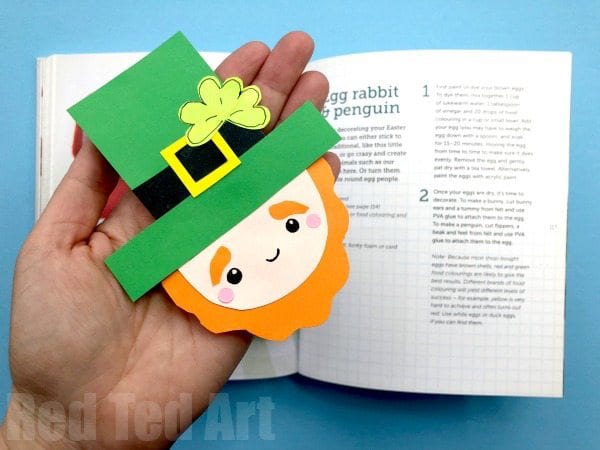 Leprechaun Bookmark Hand holding a leprechaun bookmark over an open book for a st patrick's day activity