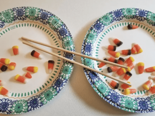 Chopstick Pick-Up Plates with candy corn and chopsticks on them