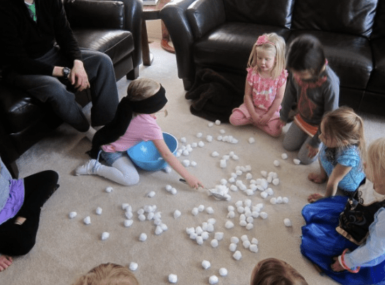 Scoop the Snowballs Kids picking up foam balls from the floor