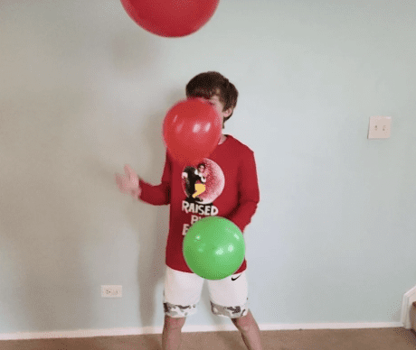 Keep The Balloon Up Kid bouncing balloons in the air