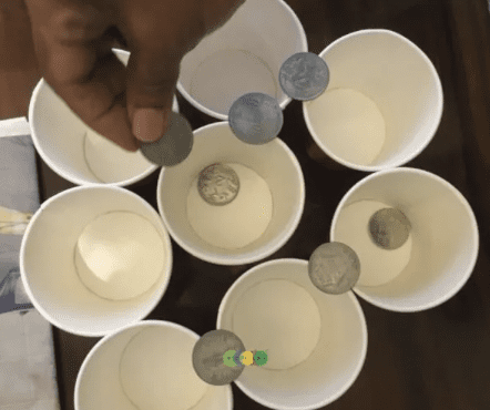 Cup And Coin Stacking Coins being stacked on cups
