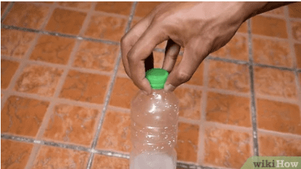 Bottle flipping Hand holding bottle cap