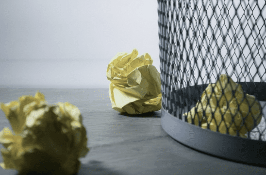 Paper Toss Rolled up paper balls next to trash can