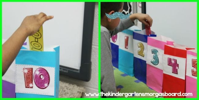 math-flash-card-sort A student's hand places a subtraction flash card into a colorful bag with the correct number written on it
