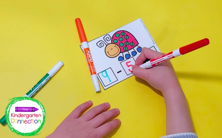 bug-subtraction A child's hands color in an insect themed subtraction problem