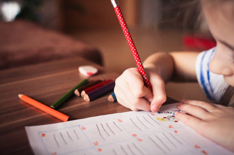 Child Writing Child writing with a red pencil