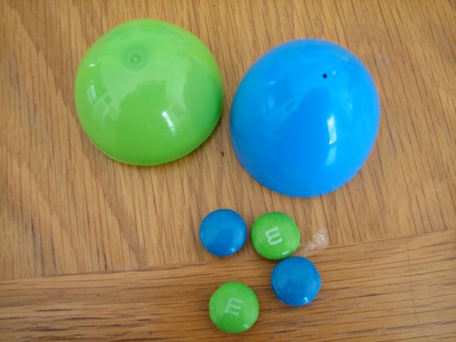 Easter Egg Activities: Punnet Squares Green and blue halves of plastic egg with two blue and two green M&Ms
