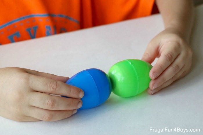 easter_egg_classroom_magnets Child hold two plastic Easter eggs together, end to end