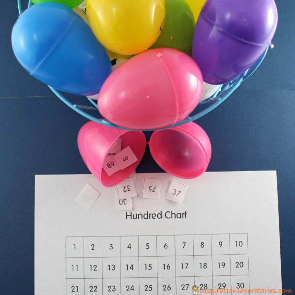 egg-hundred plastic egg activity with eggs and a hundreds board to count to one hundred