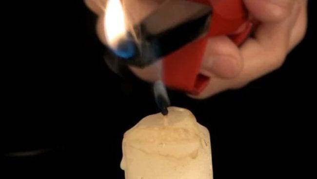 Eighth Grade Science Relight a Candle Student's hand holding a lighter over a candle that has just been blown out