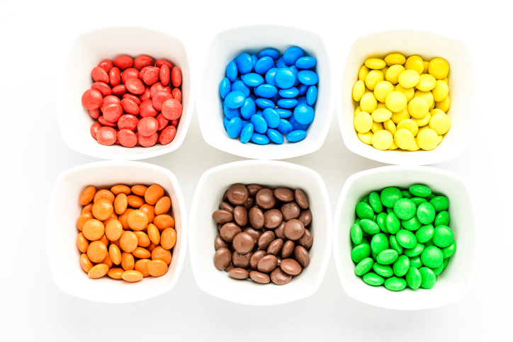 M&Ms Red, blue, yellow, orange, brown, and green candies are sorted by color.