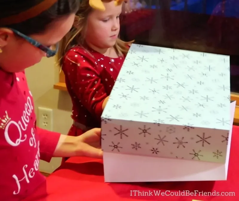 Present Game Two girls are shown unwrapping a gift in this example of minute to win it games.
