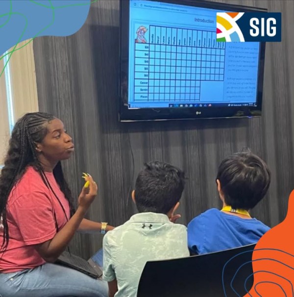 Summer Jobs for Teachers: SIG Teacher working with students at SIG summer camp (Summer Jobs for Teachers)