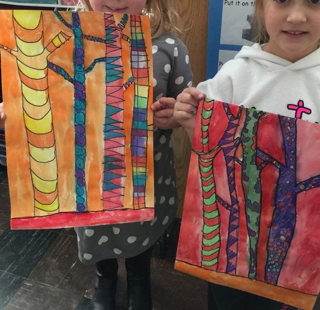 Kindergarten Art Mrs Harris Art A little girl holds up a painting of trees.