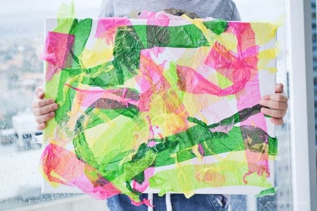 Kindergarten Art Hello Wonderful 2 A child is seen holding a large colorful piece of art made from crepe paper in this example of kindergarten art projects.