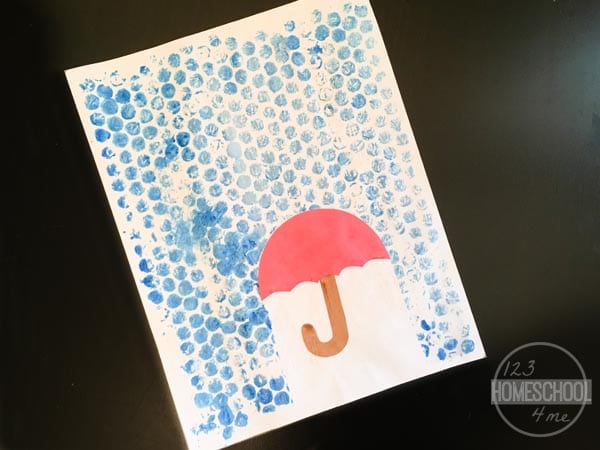 Painted Umbrella Bubble Wrap Bubble wrap is painted blue with an umbrella in this example of kindergarten art projects