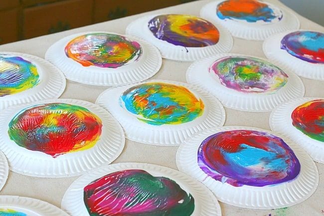 Kindergarten Art Buggy and Buddy Multiple paper plates that have been painted are shown.