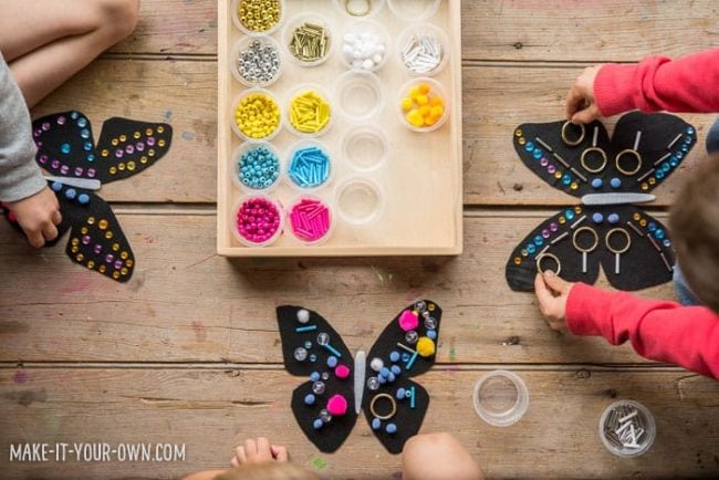 Kindergarten Art Hello Wonderful Children's arms and hands are shown making art that looks like butterflies. A palette of paints is also shown in this example of kindergarten art projects.