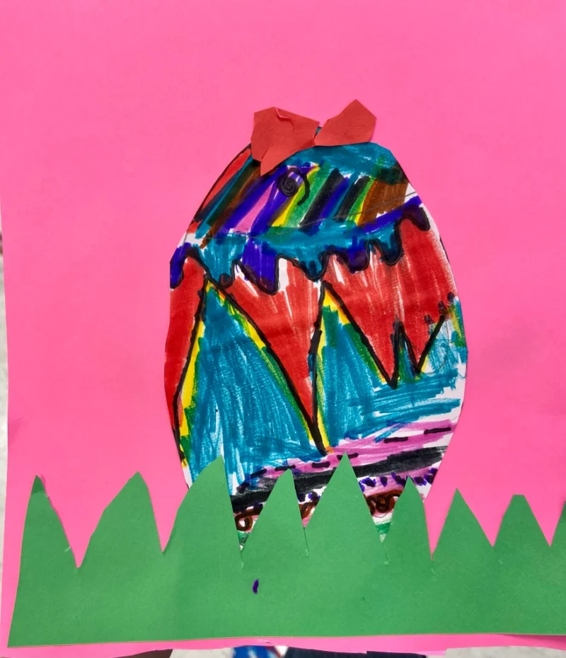 Kindergarten Art Projects: Egg A colorful egg is drawn on a pink piece of construction paper with construction paper grass.
