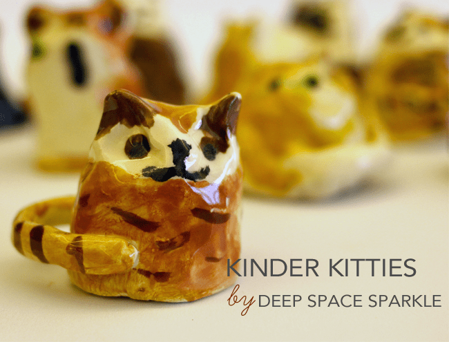 Kinder Kitties Art Cat sculptures are shown.