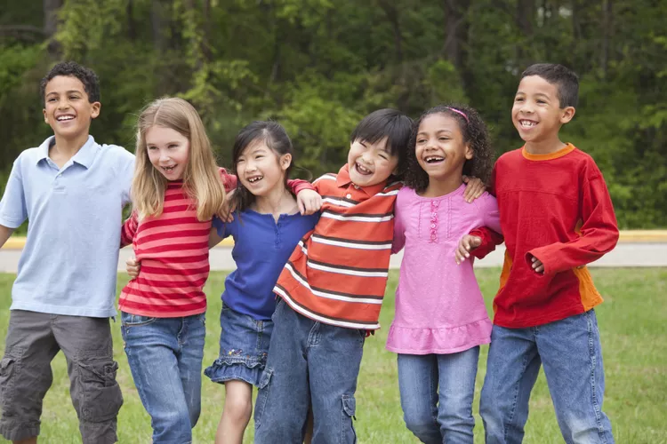 Six kids stand with arms around each other in this example of tag games.