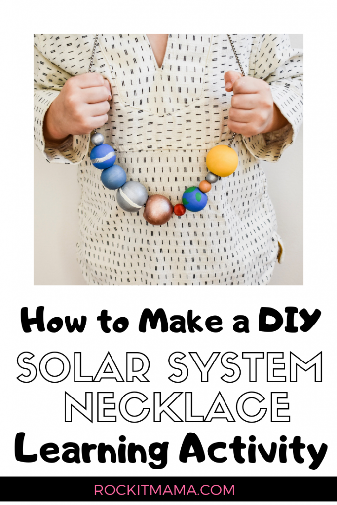 solarsystemnecklace A child's hands are shown holding a necklace that has beads in the place of planets (solar system projects)