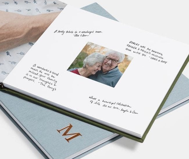 Photo book showing an older couple surrounded by hand-written messages