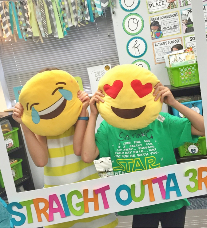 photo-booth Students with emoji pillows over face posing in a classroom photo booth