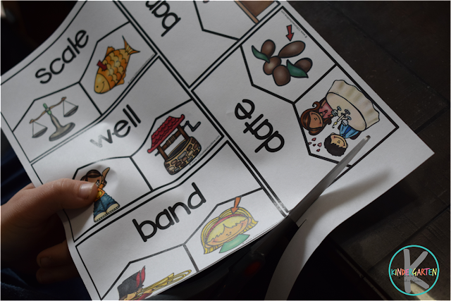 homograph-puzzles A child's hand is seen cutting out homograph puzzles as an example of grammar games