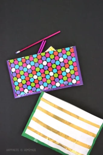 duct-tape-pouches Two zipper pouches, one with bright polka dots and one with gold and white stripes, made from duct tape