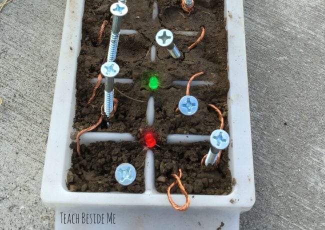 Dirt Battery Ice cube tray filled with dirt, with nails and wiring used to turn it into a baattery