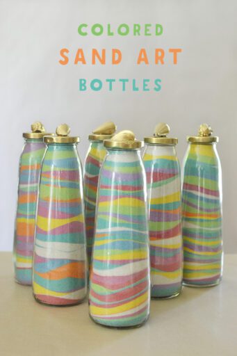 sand-art-bottles Six slim glass bottles filled with layers of colored sand inside