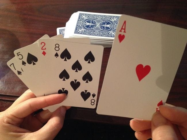 Third Grade Math Games Cuppa Cocoa Math student holding playing cards