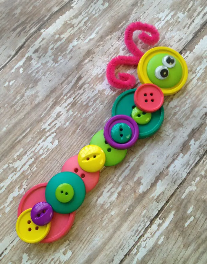 button-caterpillar Colorful buttons are glued together to create an adorable little caterpillar as an example of summer crafts for kids