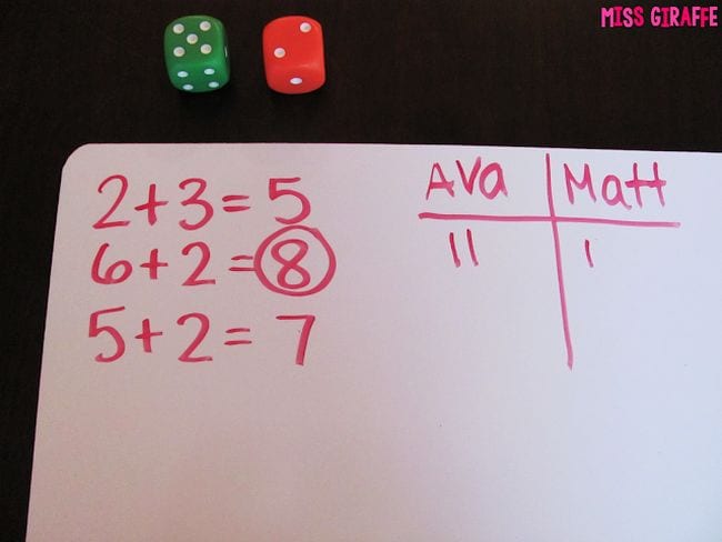 dice-war whiteboard with math equations and tally marks and dice