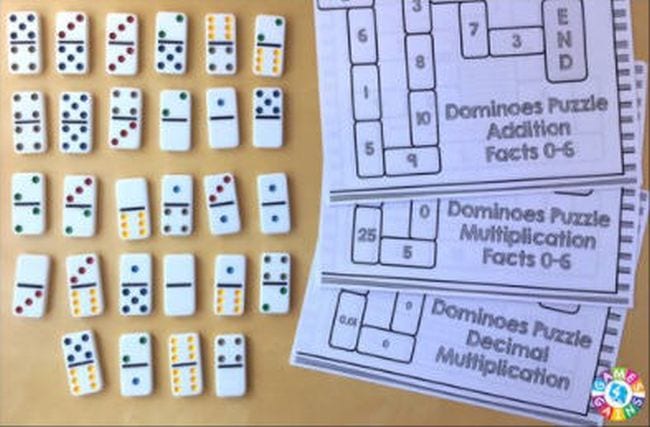 domino-puzzle dominos on a table with a page of domino puzzles, math facts games