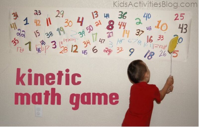 flyswatter child with fly swatter hitting at letters on a wall
