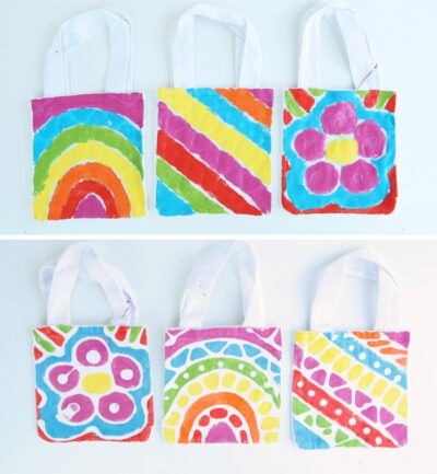 batik-tote-bags Six small tote bags with brightly colored batik designs printed on them