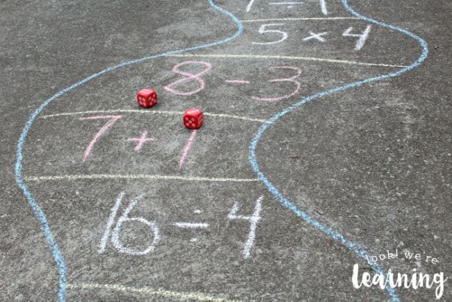 hopscotch path drawn with chalk and math equations drawn on asphalt