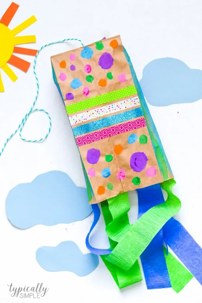 paper-bag-kite A colorful DIY kite made from a brown paper bag, paint and streamers as an example of summer crafts for kids